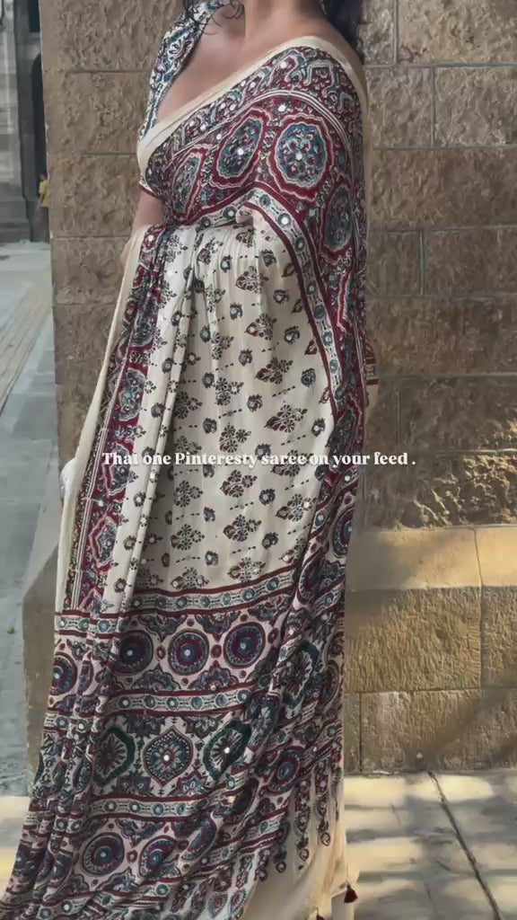 Product video showcasing a premium Ajrakh inspired Modal Silk saree with real mirror work, elegant drape, soft luxurious fabric and perfect for party wear, wedding and festive occasions for women.